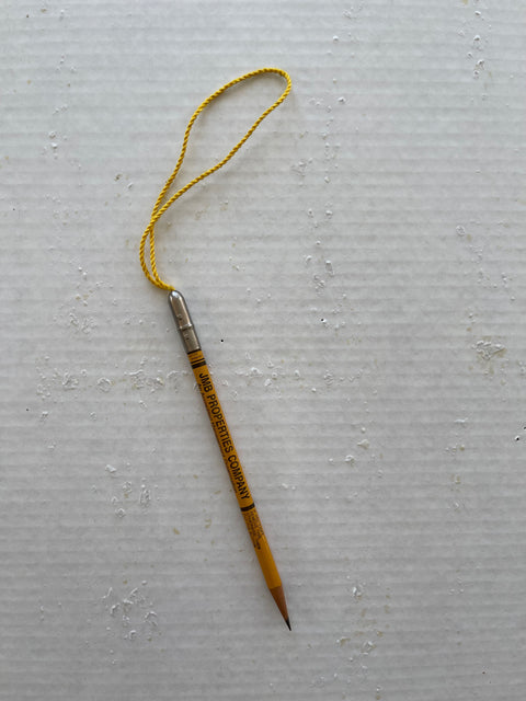 A PENCIL ON A STRING.